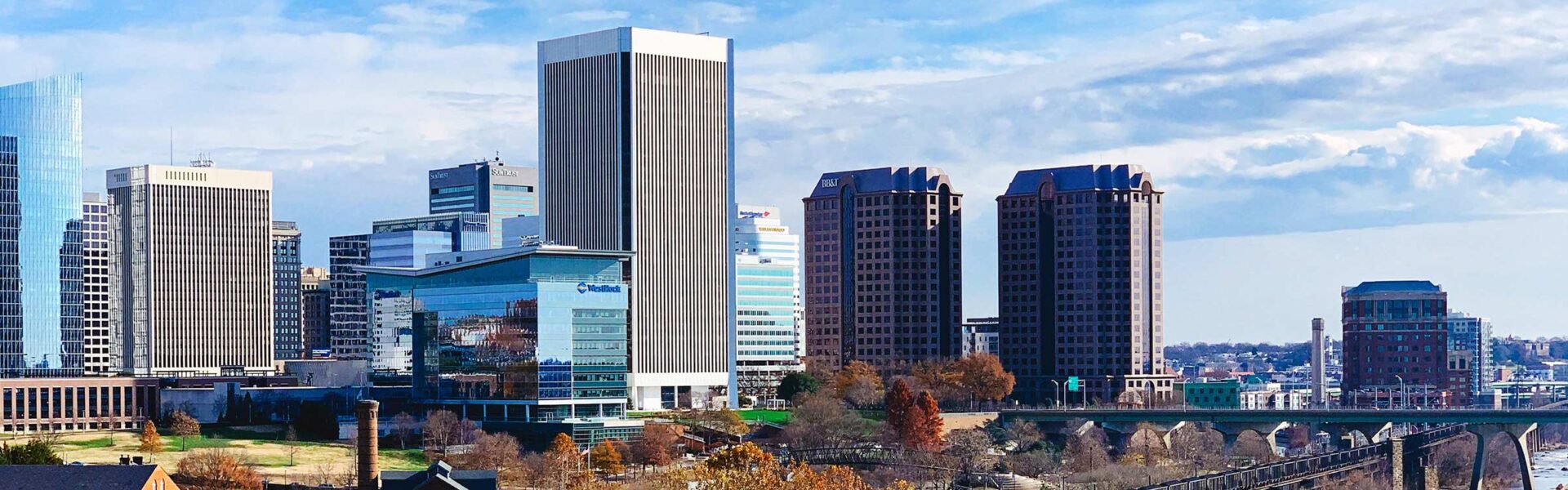 The skyline of Richmond, Virginia in the daytime with with skyscrapers in the foreground.
