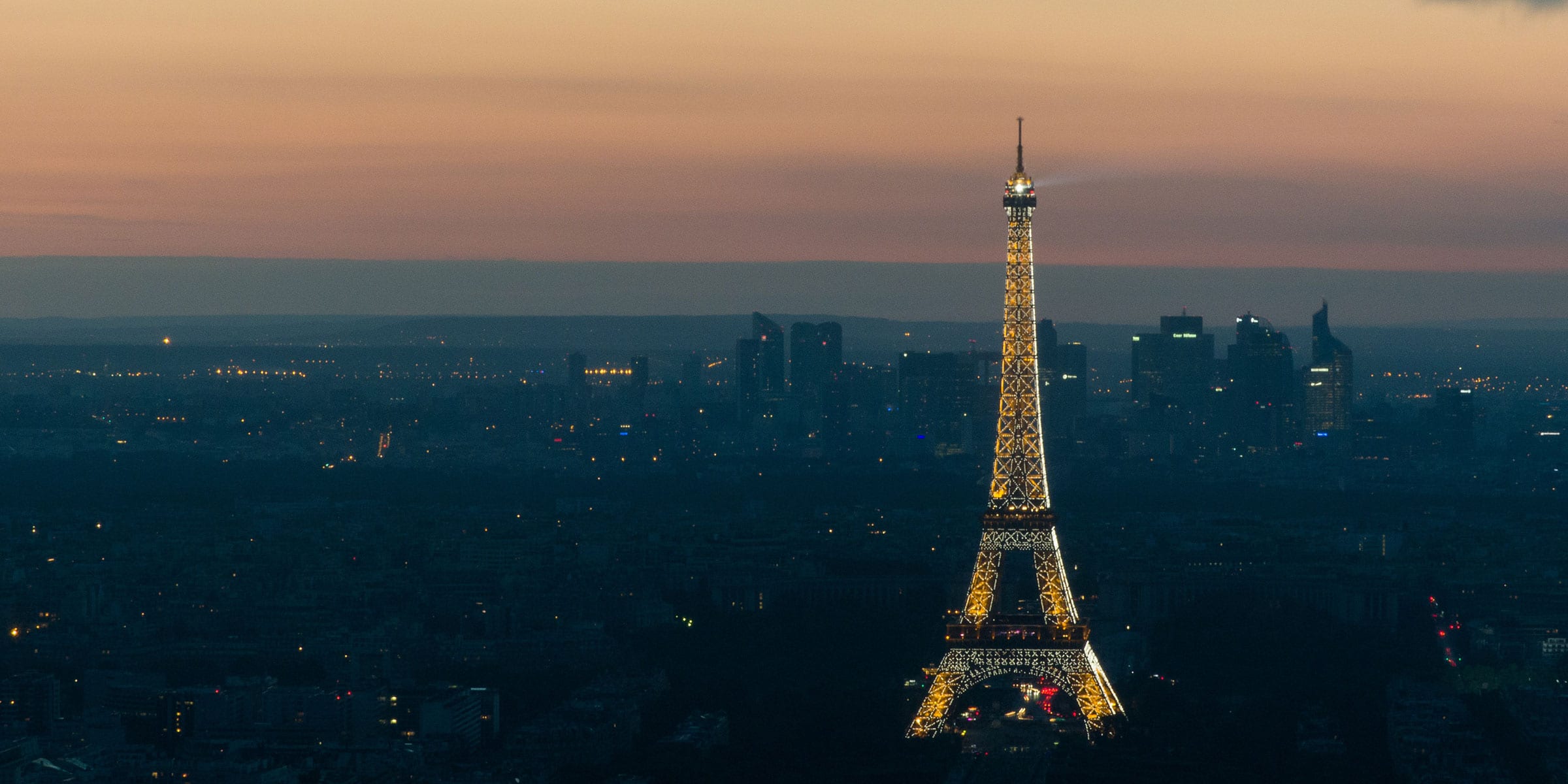 The city of Paris at Sunset with the Eiffel Tower in lights