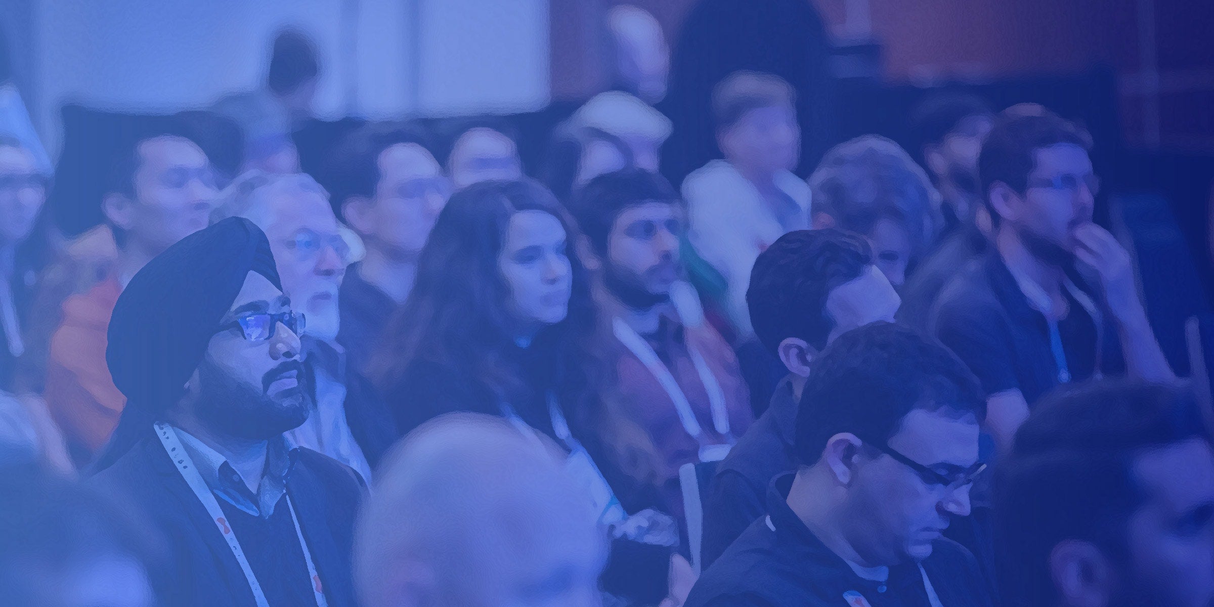 Conference attendees listening to a speaker.