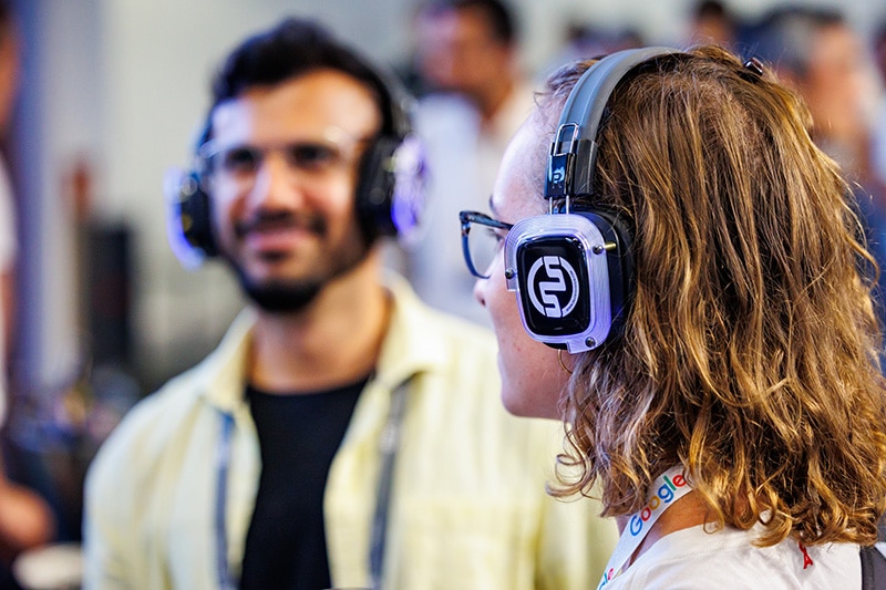 Two attendees with headphones on