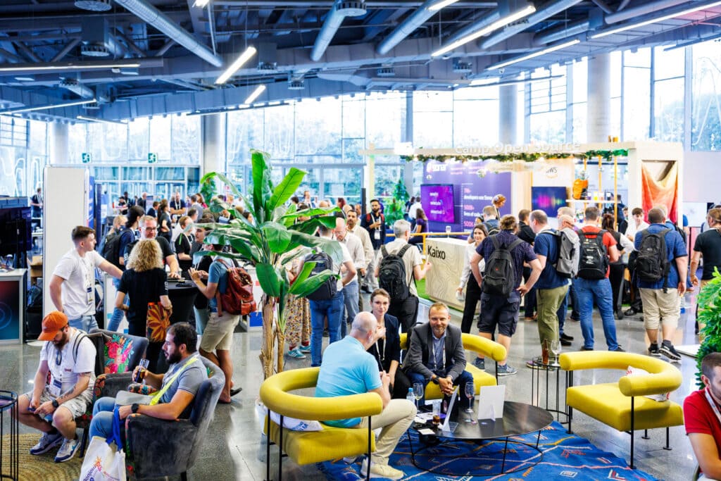 People gathered around booths at a conference