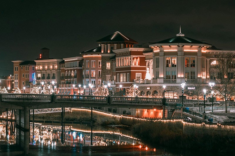 A row of buildings along a river in the evening.