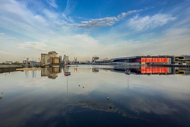 The ExCeL London building and surrounding buildings from the view of the water.