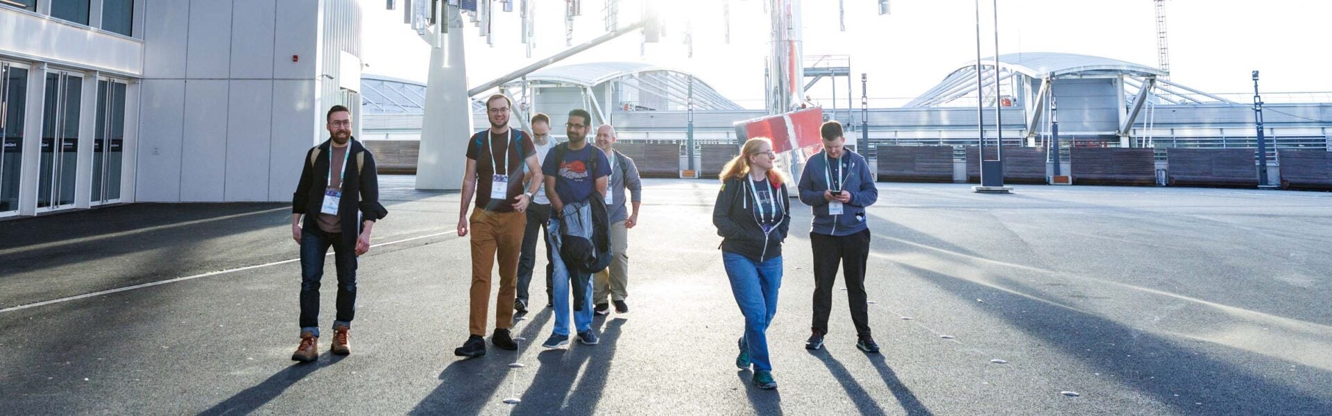 Attendees walking outside of the venue on a sunny day.