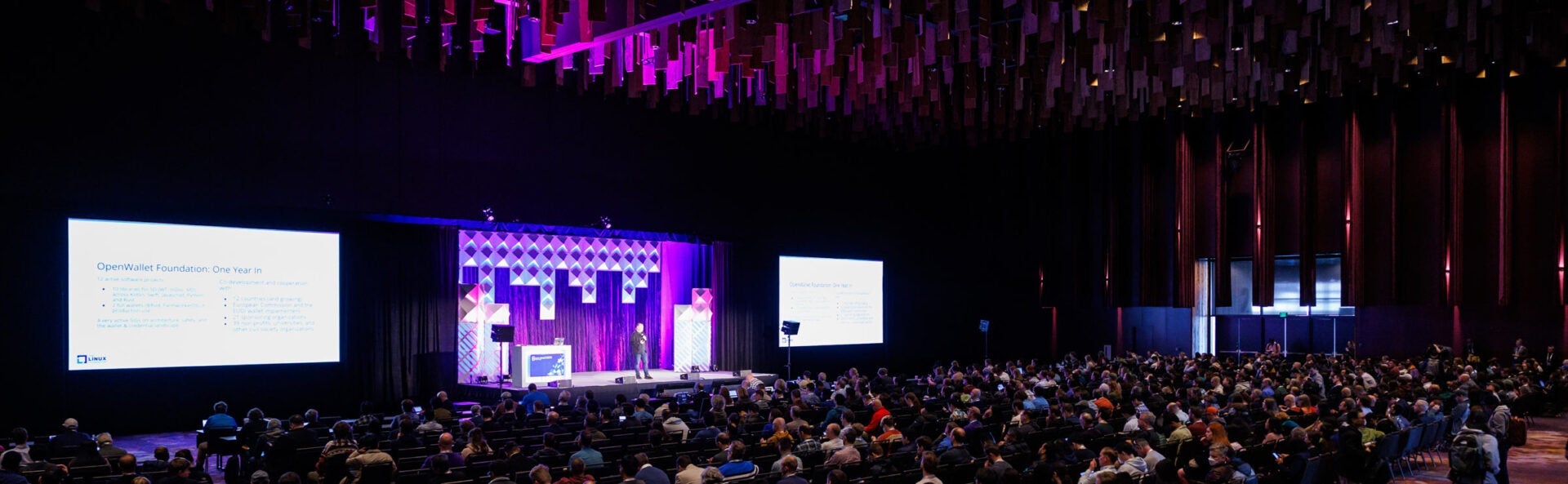 A speaker on stage in the keynotes room at an event.