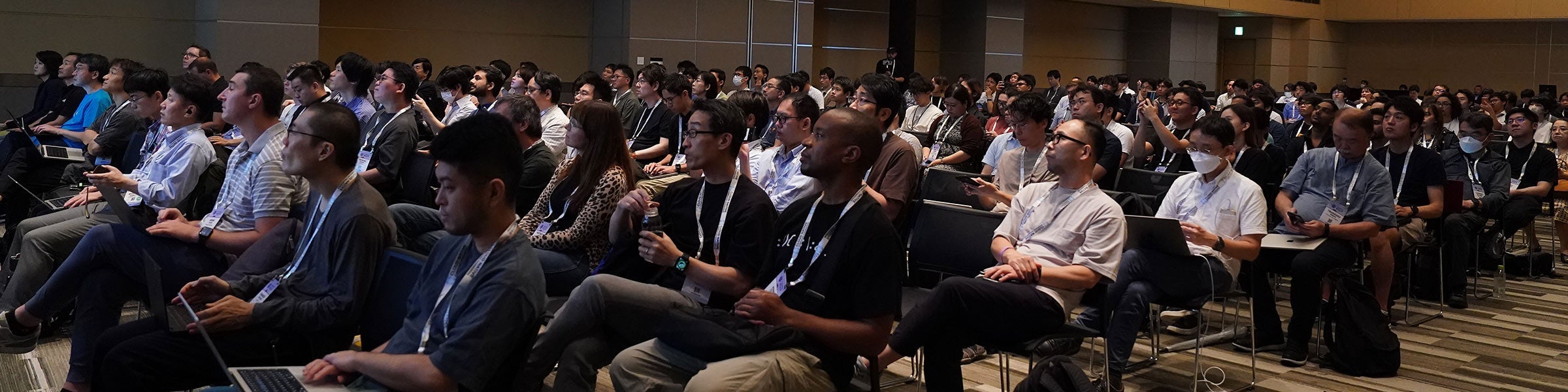 Attendees seated in a large conference room.