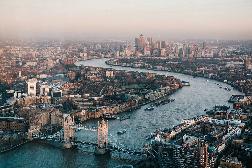 An aerial view of London with the river running through it.