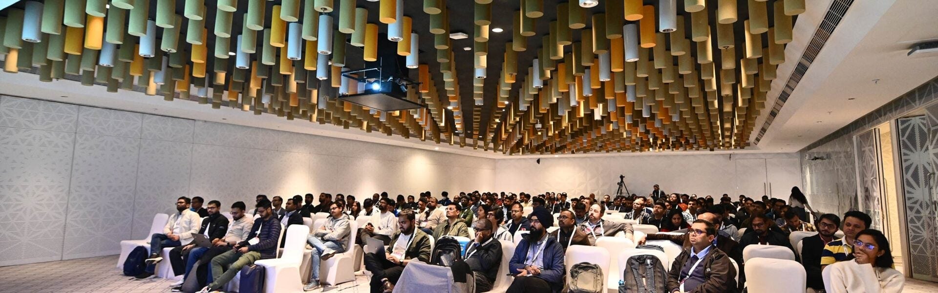 A group of attendees seated in a conference room listening to the speaker.