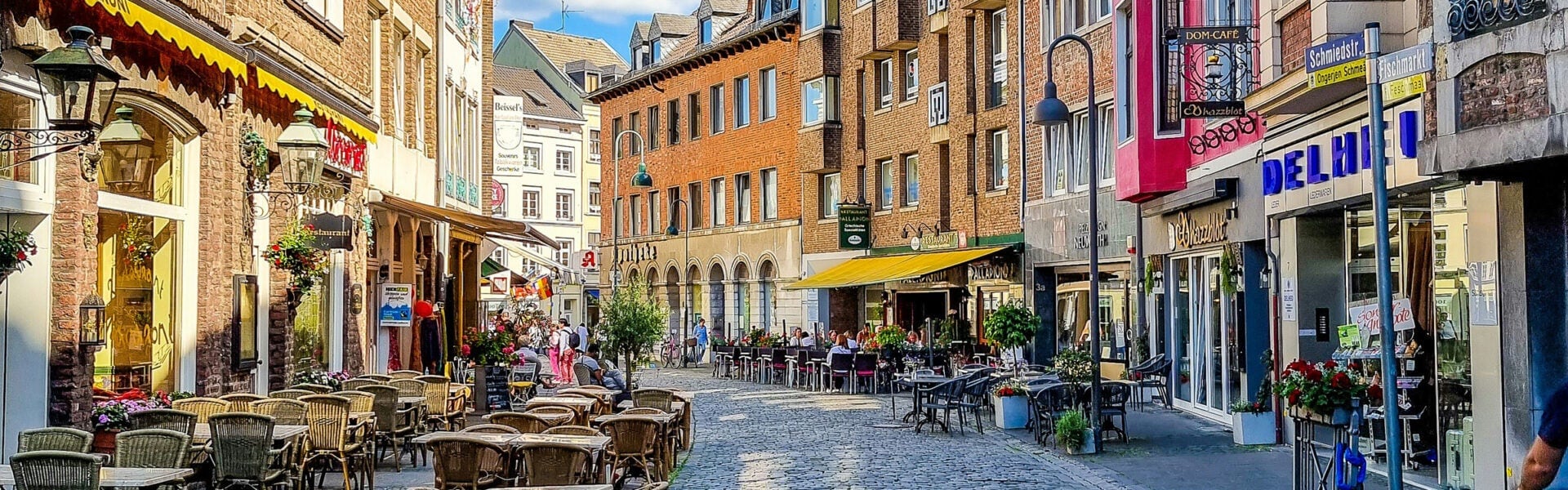 A street with businesses and tables.