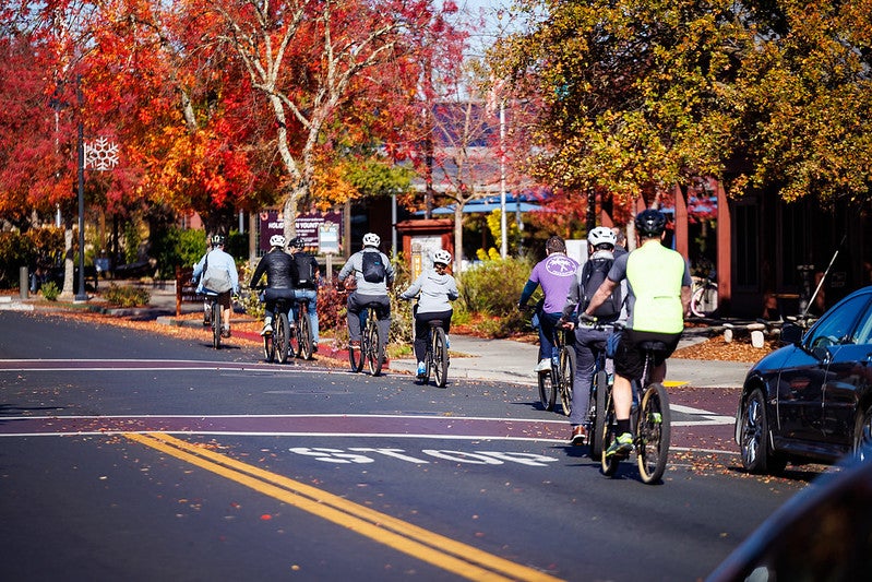 A group of people riding bikes.