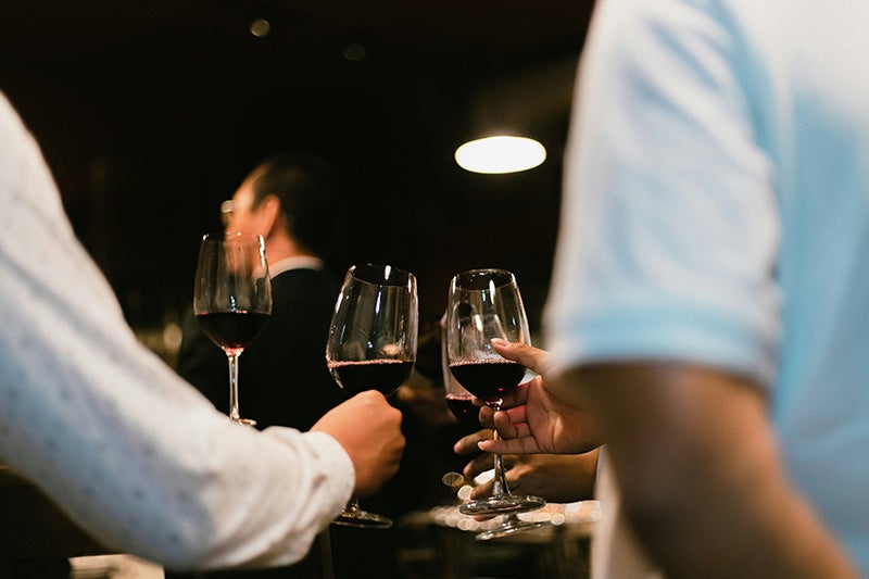 A group of people drinking wine.