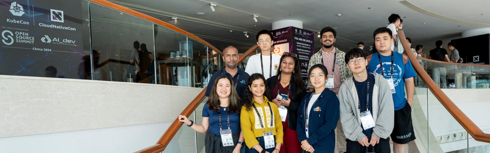 A group photo of attendees standing on a set of stairs.