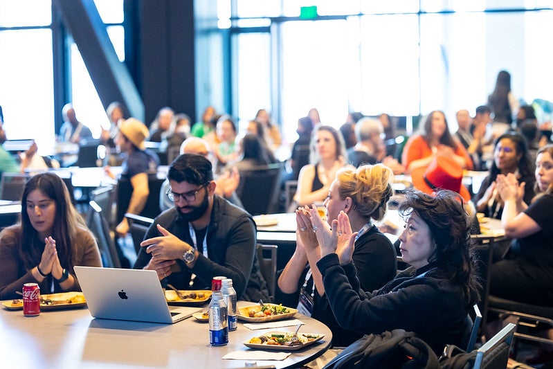 A diverse group of people eating lunch together.