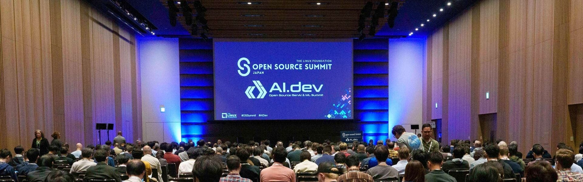 Attendees seated in the keynote room with a screen that says Open Source Summit Japan and AI_dev