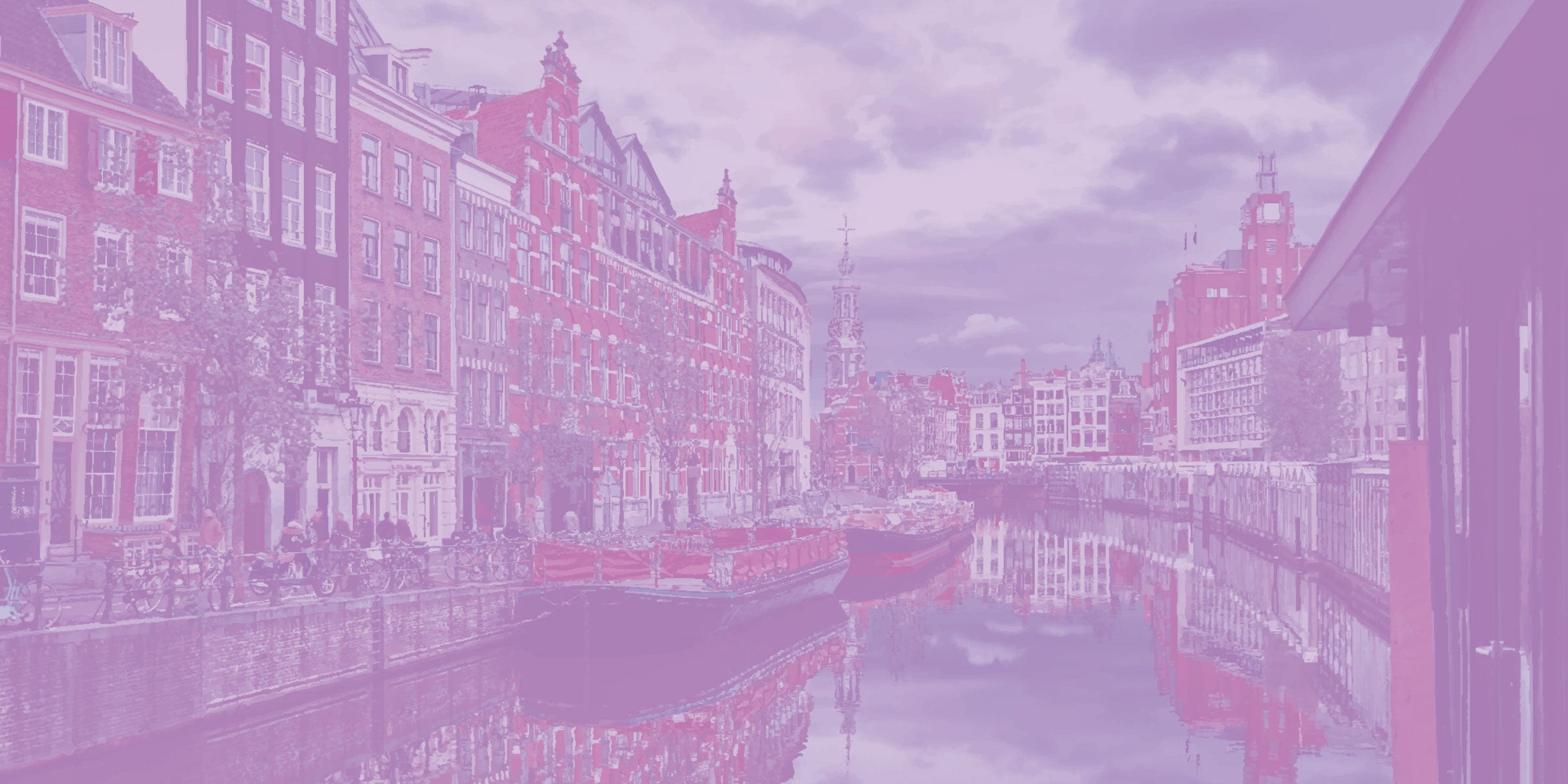 Brick buildings lining the river in Amsterdam.