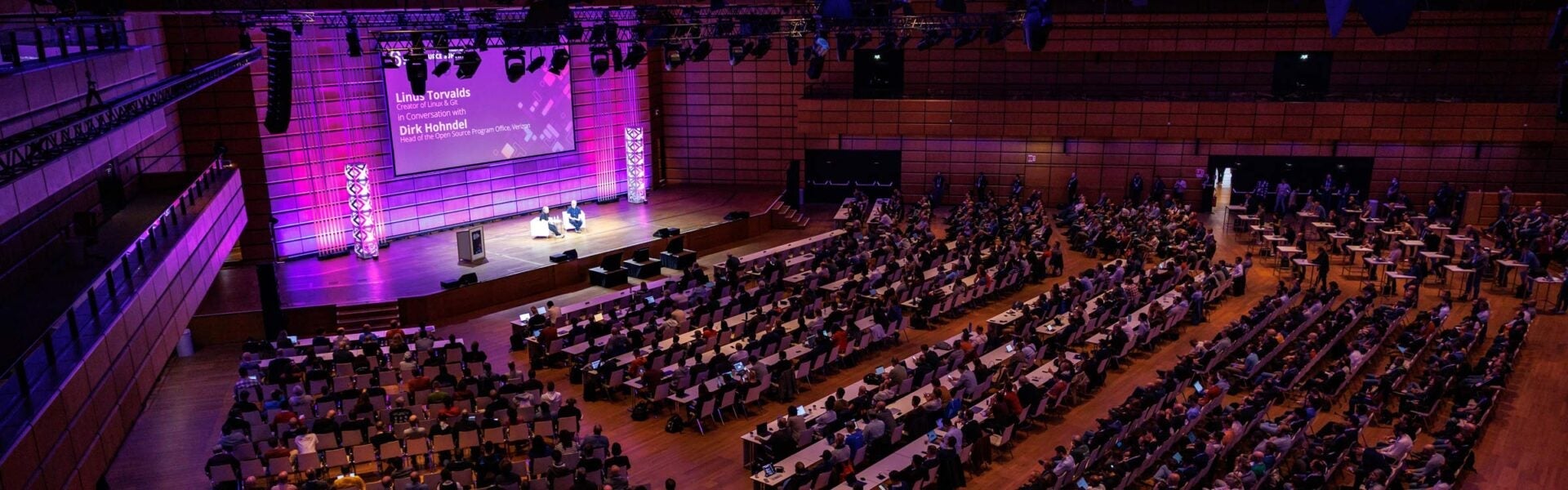 A large keynote speaker room filled with attendees.