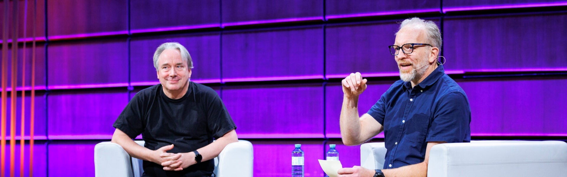 Linus Torvalds & Dirk Hohndel seated on the keynote stage addressing the audience.