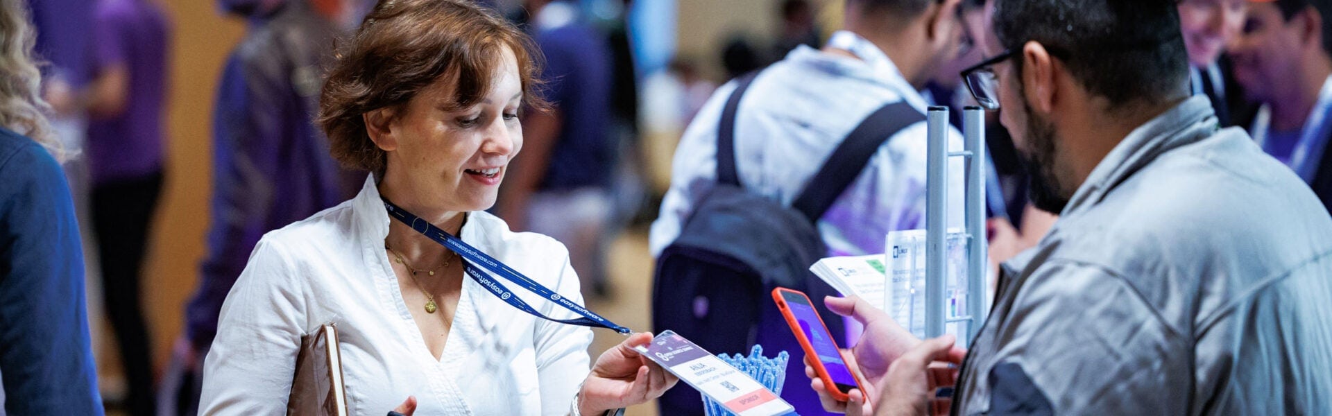 A woman getting her badge scanned by a sponsor.