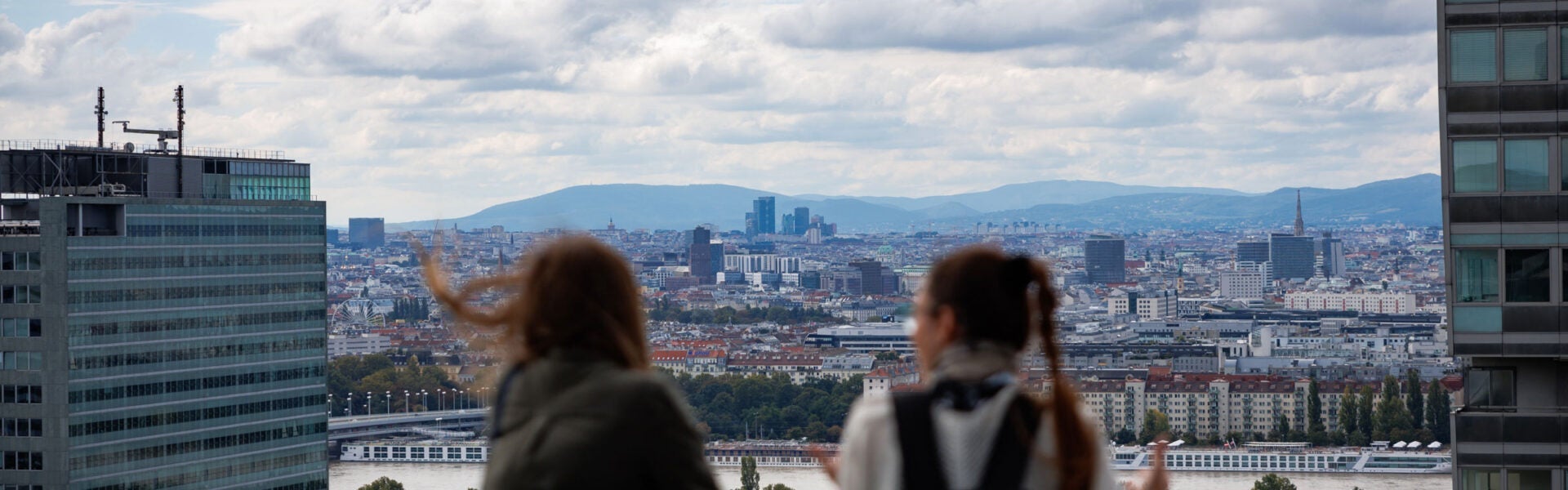 Two women looking at the view of the city.