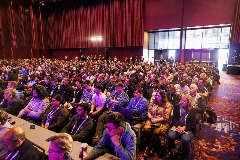 A meeting room full of people.