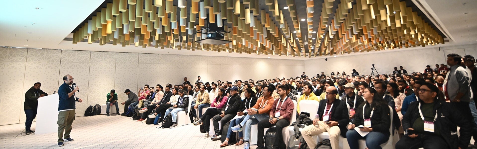 A room full of attendees listening to a speaker.