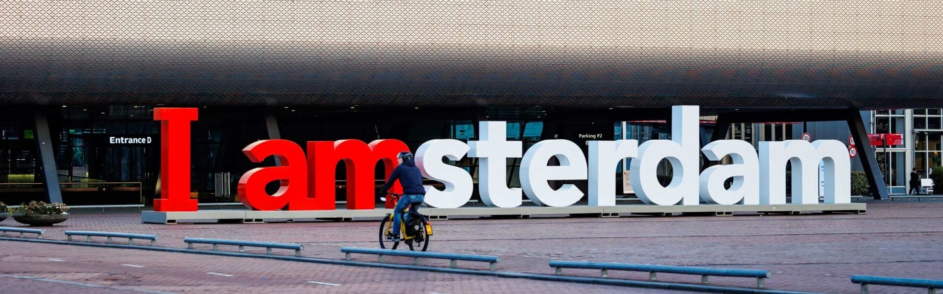 A 3-D sign that reads I amsterdam outside of a venue.