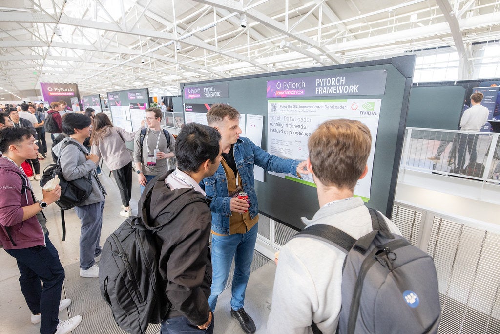 Attendees looking at information displayed on posters