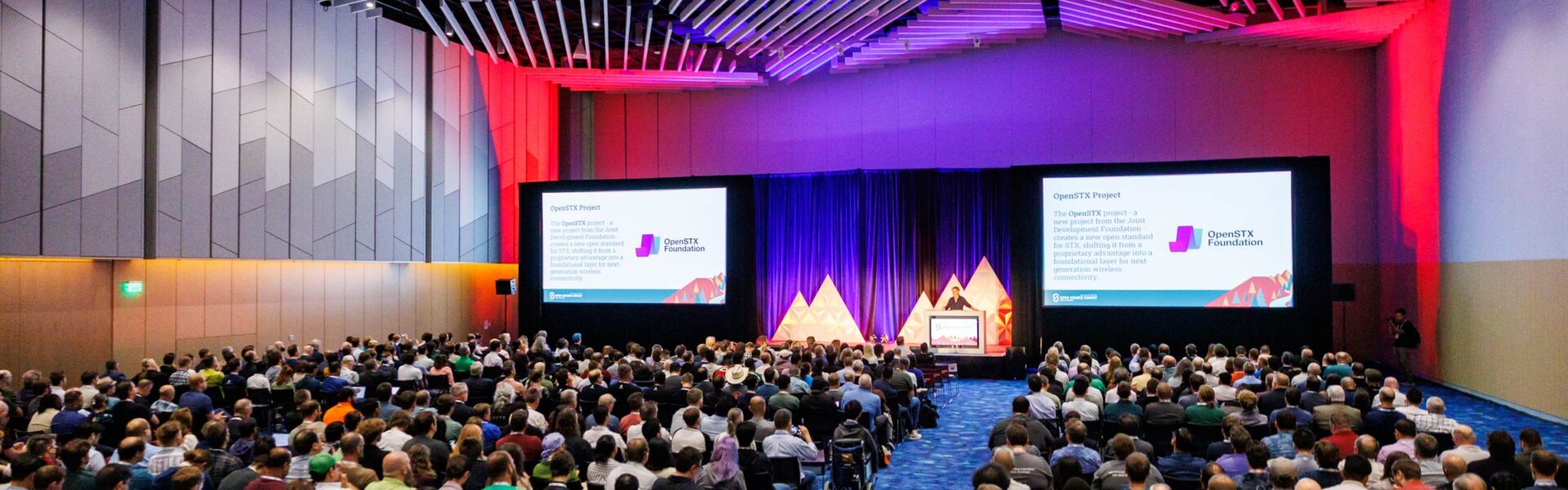 A seated crowd listening to a keynote speaker