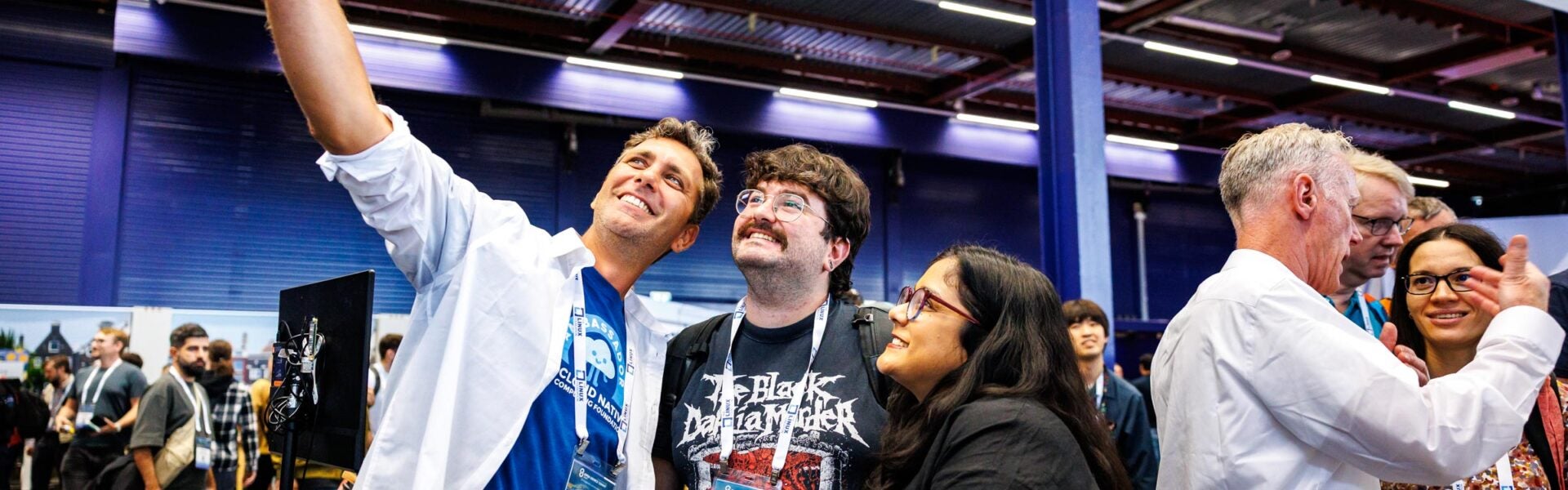 Conference attendees taking a group selfie