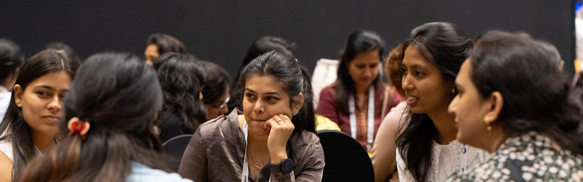 Small group of attendees seated together in discussion during a conference breakout session