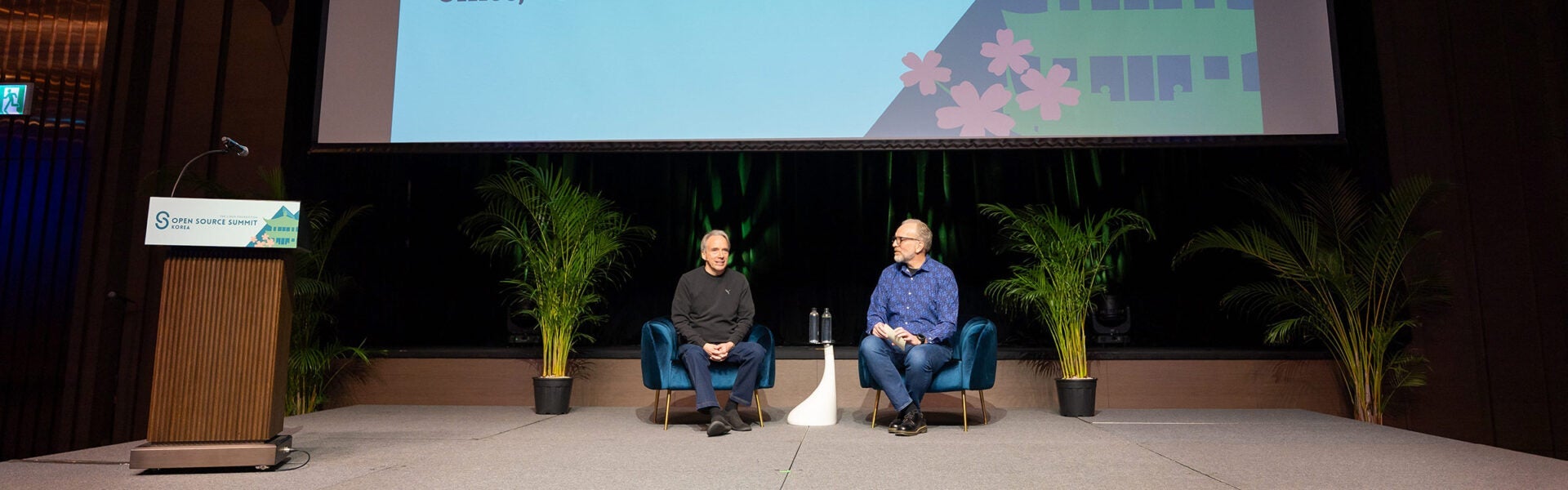 Two speakers seated on stage during a keynote discussion at Open Source Summit Korea.