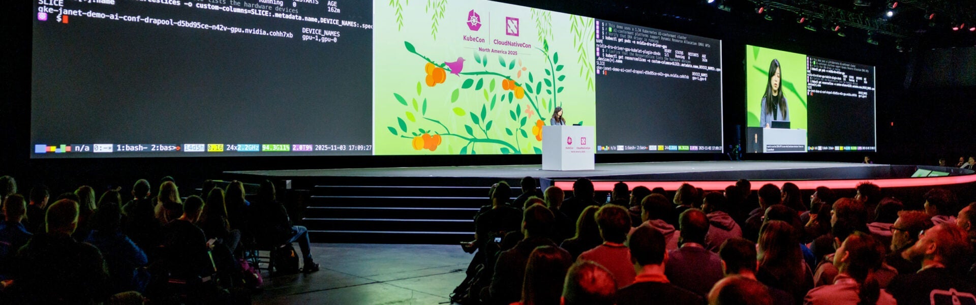 Speaker presents technical content on a large stage during a keynote session.