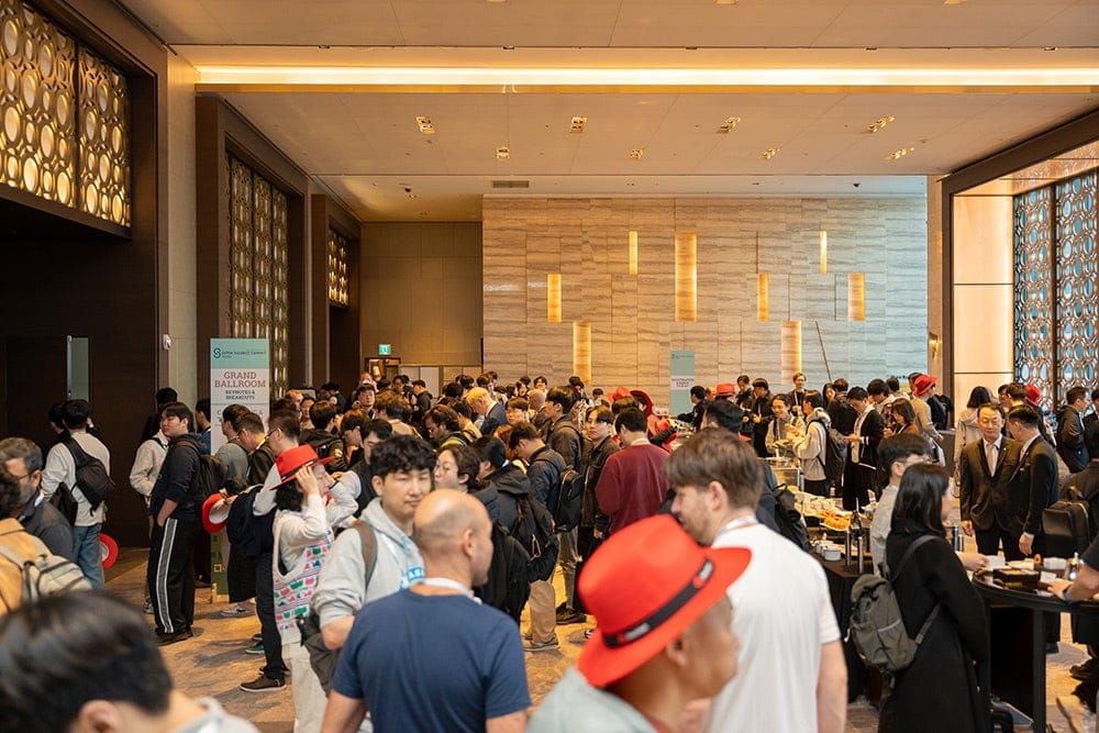 Large crowd of attendees gathered in a conference lobby
